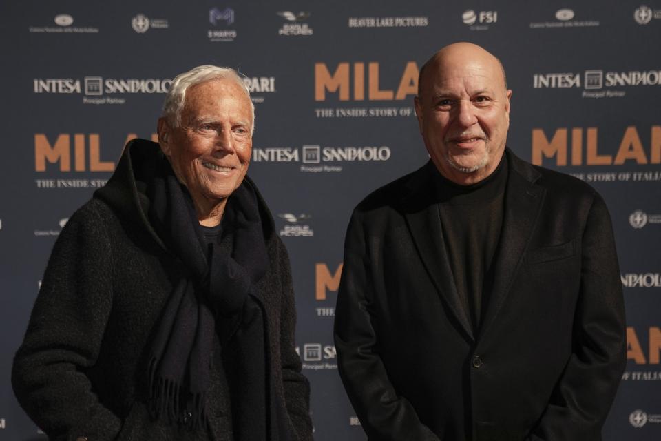 Designer Giorgio Armani, left, and producer Alan Friedman pose for photographers upon arrival for the premiere of the film 'Milano, the inside story of Milan Fashion' in Milan, Italy, Sunday, Feb. 26, 2023. (AP Photo/Luca Bruno)