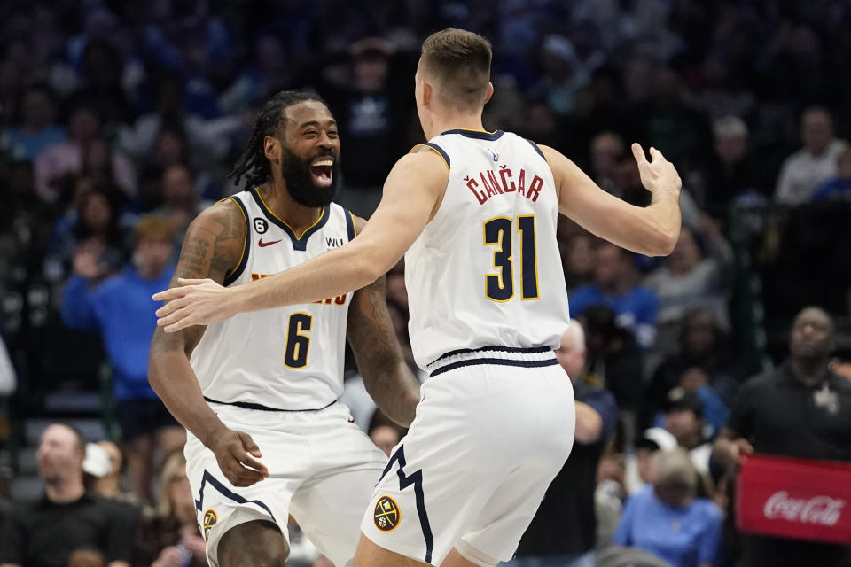 Denver Nuggets forward Vlatko Cancar (31) celebrates with teammate DeAndre Jordan (6) after Cancar scored a 3-point basket at the end of the first half of an NBA basketball game against the Dallas Mavericks in Dallas, Sunday, Nov. 20, 2022. The Nuggets won 98-97. (AP Photo/LM Otero)