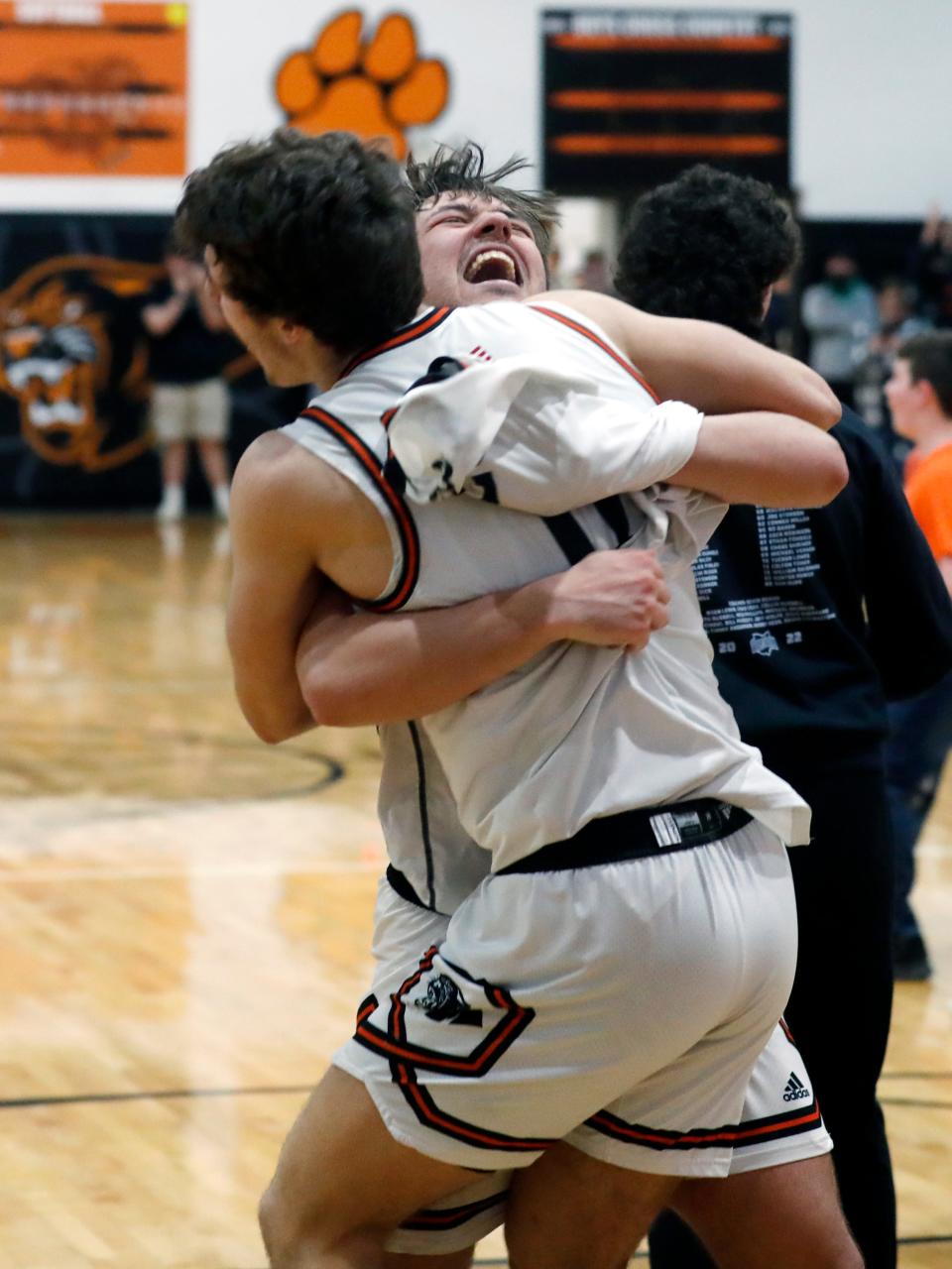 Seniors Lukas Ratliff, left, and Ryan Hobbs embrace in celebration folllowing New Lexington's 49-43 overtime win against visiting Ironton in a Division II sectional final on Saturday night in New Lexington. The Panthers overcame a 10-point fourth-quarter deficit to  claim their third sectional title in four years and second straight.