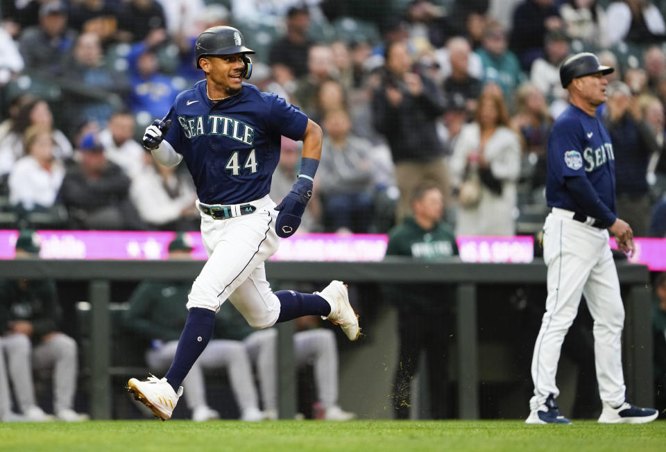 Seattle Mariners' Julio Rodriguez runs home to score on a single from Jarred Kelenic against the Oakland Athletics during the fifth inning of a baseball game, Monday, May 22, 2023, in Seattle. (AP Photo/Lindsey Wasson)