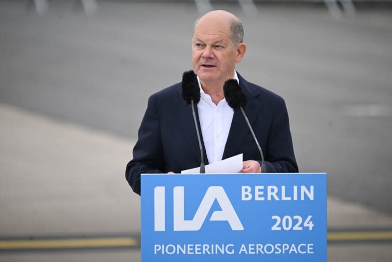 Germany's Chancellor Olaf Scholz speaks during the opening tour of the International Aerospace Exhibition (ILA) on the grounds of Berlin Brandenburg Airport (BER). Sebastian Christoph Gollnow/dpa