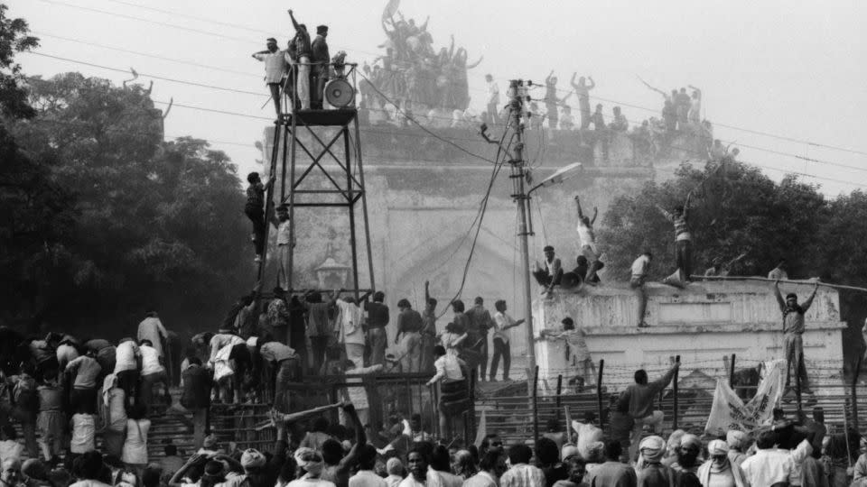 Hindu fundamentalists  climb the dome of Babri Masjid in Ayodhya to demolish the structure on December 6, 1992.  - Sondeep Shankar/Hulton Archive/Getty Images