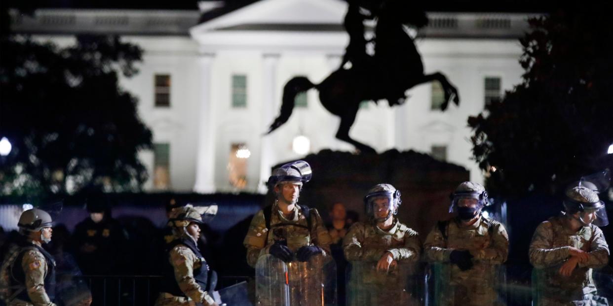 A line of DC National Guard members stand in Lafayette Park as demonstrators gather to protest the death of George Floyd, Tuesday, June 2, 2020, near the White House in Washington. Floyd died after being restrained by Minneapolis police officers.