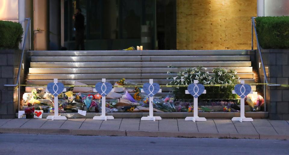 A makeshift memorial has been placed in front of the Old National Bank to honor the victims of the mass shooting, including the five who were killed by the shooter earlier in the week in Louisville, Ky. on Apr. 11, 2023.  