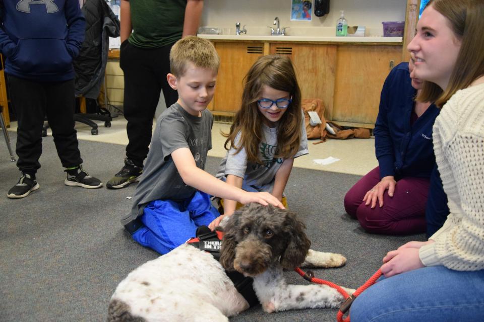 Harrison Henning and Aurora Fosmore pet Henry during his visit to Lincoln on May 5.