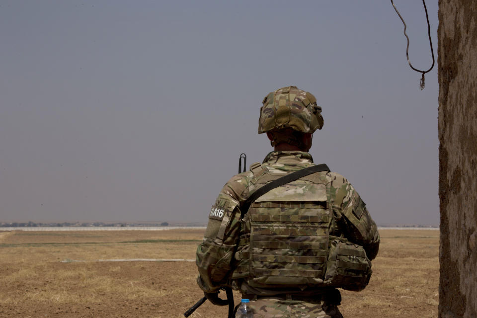 A U.S. soldier stands guard, facing the Turkish border in the safe zone near Tal Abyad, Syria, during a joint patrol Friday, Sept. 6, 2019. Once part of the sprawling territories controlled by the Islamic State group, the villages are under threat of an attack from Turkey which considers their liberators, the U.S-backed Syrian Kurdish-led forces, terrorists.T o forestall violence between its two allies along the border it has helped clear of IS militants, Washington has upped its involvement in this part of Syria.. (AP Photo/Maya Alleruzzo)