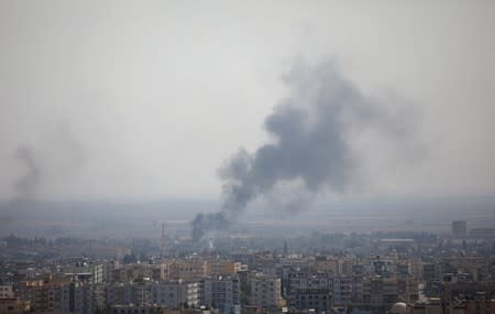 Smoke rises over the Syrian town of Ras al-Ain as seen from the Turkish border town of Ceylanpinar