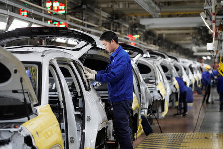 Employees work on Baojun RS-5 cars at a final assembly plant operated by General Motors Co and its local joint-venture partners in Liuzhou, Guangxi Zhuang Autonomous Region, China, February 28, 2019. REUTERS/Aly Song