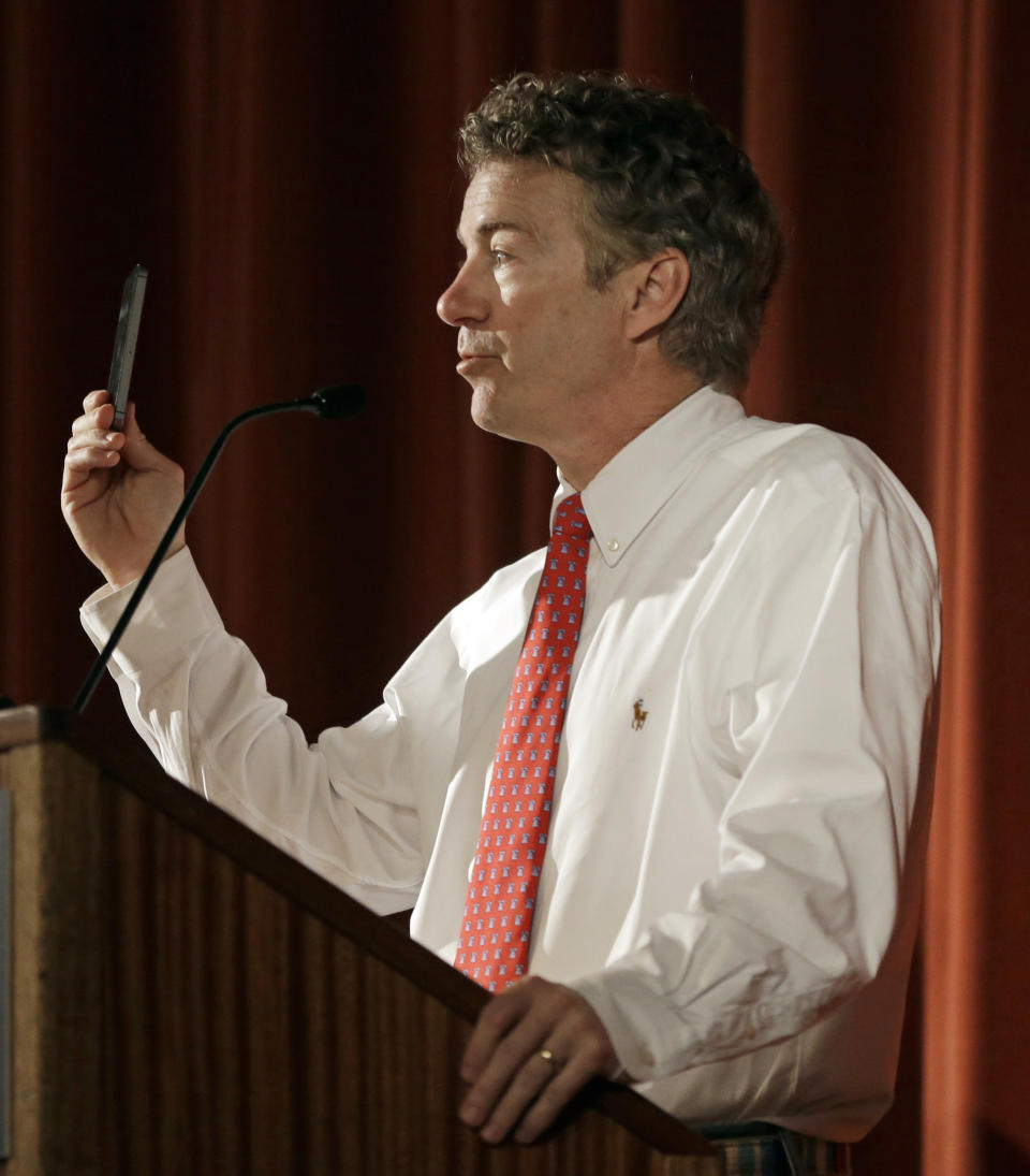 U.S. Sen. Rand Paul, R-Ky., holds his phone while speaking before the Berkeley Forum, Wednesday, March 19, 2014, in Berkeley, Calif. (AP Photo/Ben Margot)