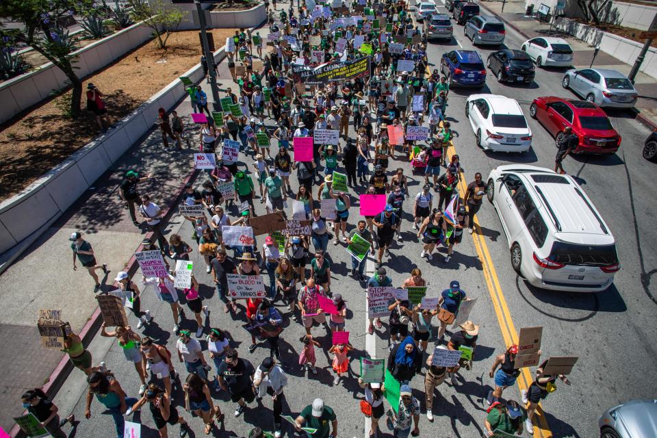 Protesters hold placards during a demonstration in downtown Los Angeles on June 26, 2022, two days after the U.S. Supreme Court released a decision in Dobbs v. Jackson Women's Health Organization, striking down the constitutional right to abortion. (Apu Gomes/AFP via Getty Images)