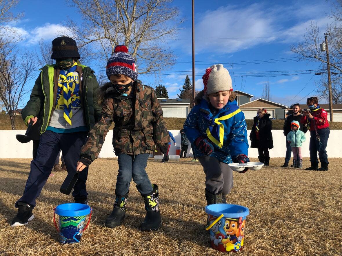 These beavers and cubs with Infinity Scouts are learning about irrigation and the best ways to transport water. (Colleen Underwood/CBC - image credit)