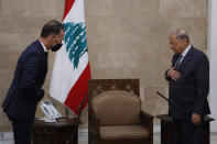 In this photo released by Lebanon's official government photographer Dalati Nohra, Lebanese president Michel Aoun, right, meets with German Foreign Minister Heiko Maas, at the Presidential Palace in Baabda, east of Beirut, Lebanon, Wednesday, Aug. 12, 2020. Maas said that Lebanon needs a "strong reboot" and far-reaching economic reforms to rebuild trust with its citizens. Heiko Maas spoke ahead of his trip to Beirut, following last week's explosion at the city's port that killed at least 171 people and wounded thousands. (Dalati Nohra via AP)