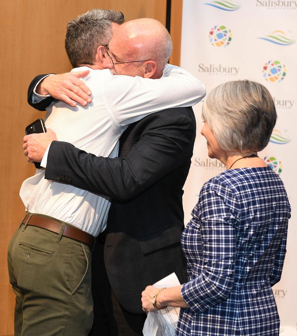Jake Day, left, hugs his father, Perdue Farms CEO Randy Day, as his mother, Debbie, a retired teacher, looks on at Salisbury University on Jan. 26, 2023, to celebrate Jake Day's nomination to join the cabinet of Gov. Wes Moore to lead the Department of Housing & Community Development.