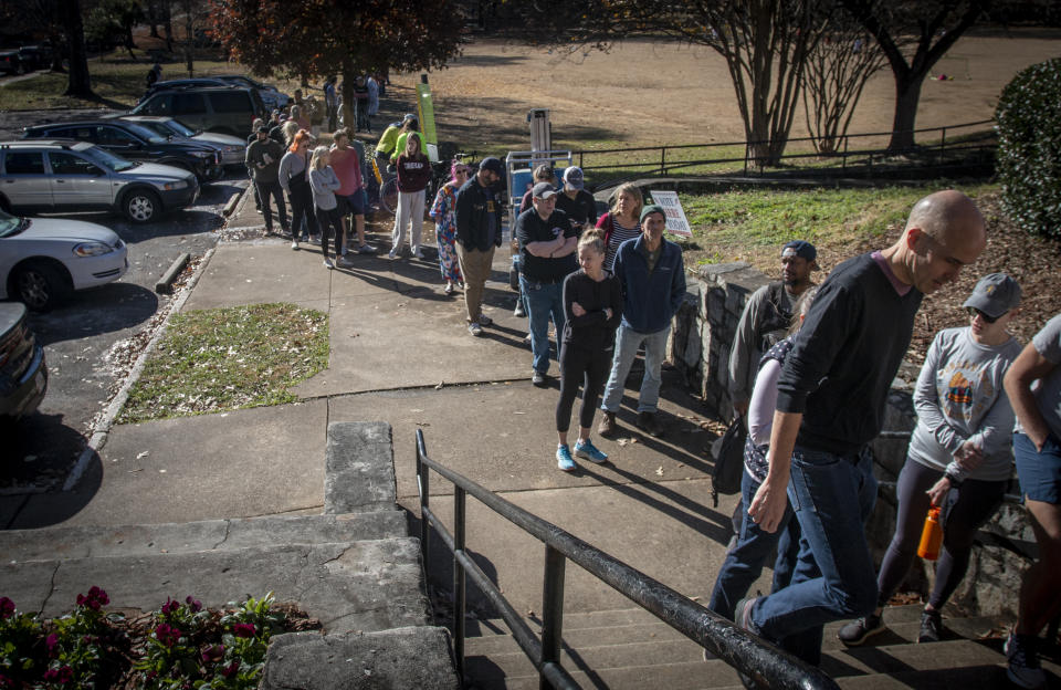 Voters wait in a growing line to cast their ballots at the Bessie Branham Park polling location on Sunday, Nov. 27, 2022, in Atlanta. The extended Senate campaign in Georgia between the Democratic incumbent, Raphael Warnock, and his Republican challenger, football legend Herschel Walker, has grown increasingly bitter as their Dec. 6 runoff nears. (AP Photo/Ron Harris)