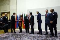 British Foreign Secretary William Hague, Germany's Foreign Minister Guido Westerwelle, European Union foreign policy chief Catherine Ashton, Iranian Foreign Minister Mohammad Javad Zarif, Chinese Foreign Minister Wang Yi, U.S. Secretary of State John Kerry, Russia's Foreign Minister Sergei Lavrov and French Foreign Minister Laurent Fabius (L-R) shake hands after a ceremony at the United Nations in Geneva November 24, 2013. REUTERS/Denis Balibouse