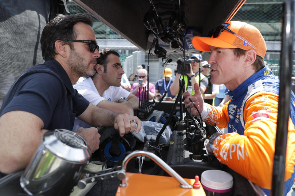 FILE - NASCAR driver Jimmie Johnson, left, and Indycar driver Scott Dixon, right, talk during practice for the Indianapolis 500 IndyCar auto race at Indianapolis Motor Speedway in Indianapolis, in this May 16, 2019, file photo. Johnson and Dixon will be competing in the Rolex 24 at Daytona endurance race that begins next Saturday, Jan. 29, 2022, at 1:30m p.m. ET. (AP Photo/Michael Conroy, File)