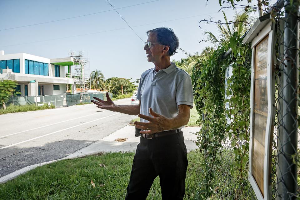 Northwood Shores neighborhood association president Carl Flick talks with a Palm Beach Post reporter in the Northwood Shores neighborhood in West Palm Beach, Fla., on July 24, 2023. In the background is a new home being built by Scott Diament on North Flagler Drive.