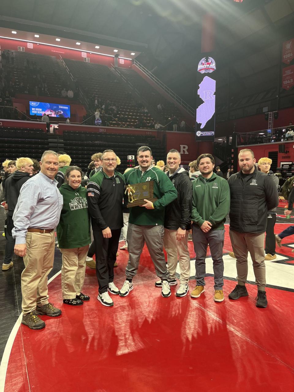 Head coach Roy Dragon III (center) and the Ridge staff after the Red Devils won the Group 4 wrestling title at Rutgers on Feb. 11, 2024