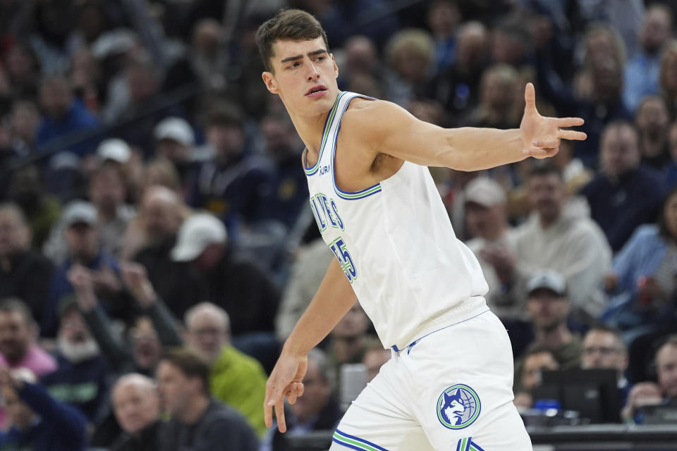 Minnesota Timberwolves center Luka Garza gestures after making a 3-point shot against the Denver Nuggets during the first half of an NBA basketball game Tuesday, March 19, 2024, in Minneapolis. (AP Photo/Abbie Parr)