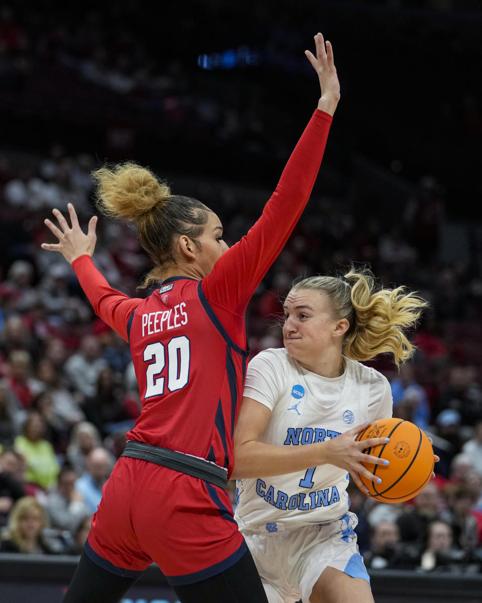 St. John's forward Rayven Peeples (20) defends North Carolina guard Alyssa Ustby (1) in the first half of a second-round college basketball game in the women's NCAA Tournament in Columbus, Ohio, Saturday, March 18, 2023. (AP Photo/Michael Conroy)