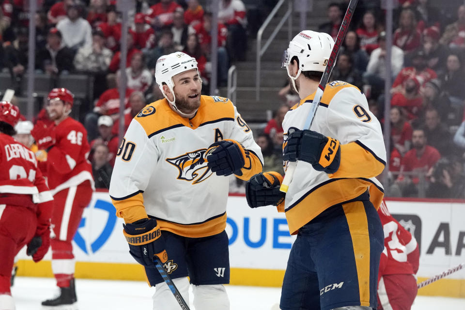 Nashville Predators left wing Filip Forsberg (9) is greeted buy center Ryan O'Reilly (90) after scoring during the first period of an NHL hockey game against the Detroit Red Wings, Friday, Dec. 29, 2023, in Detroit. (AP Photo/Carlos Osorio)