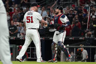 Atlanta Braves relief pitcher Will Smith (51) and Atlanta Braves catcher Travis d'Arnaud (16) celebrate after defeating the Philadelphia Phillies in a baseball game Tuesday, Sept. 28, 2021, in Atlanta. (AP Photo/John Bazemore)