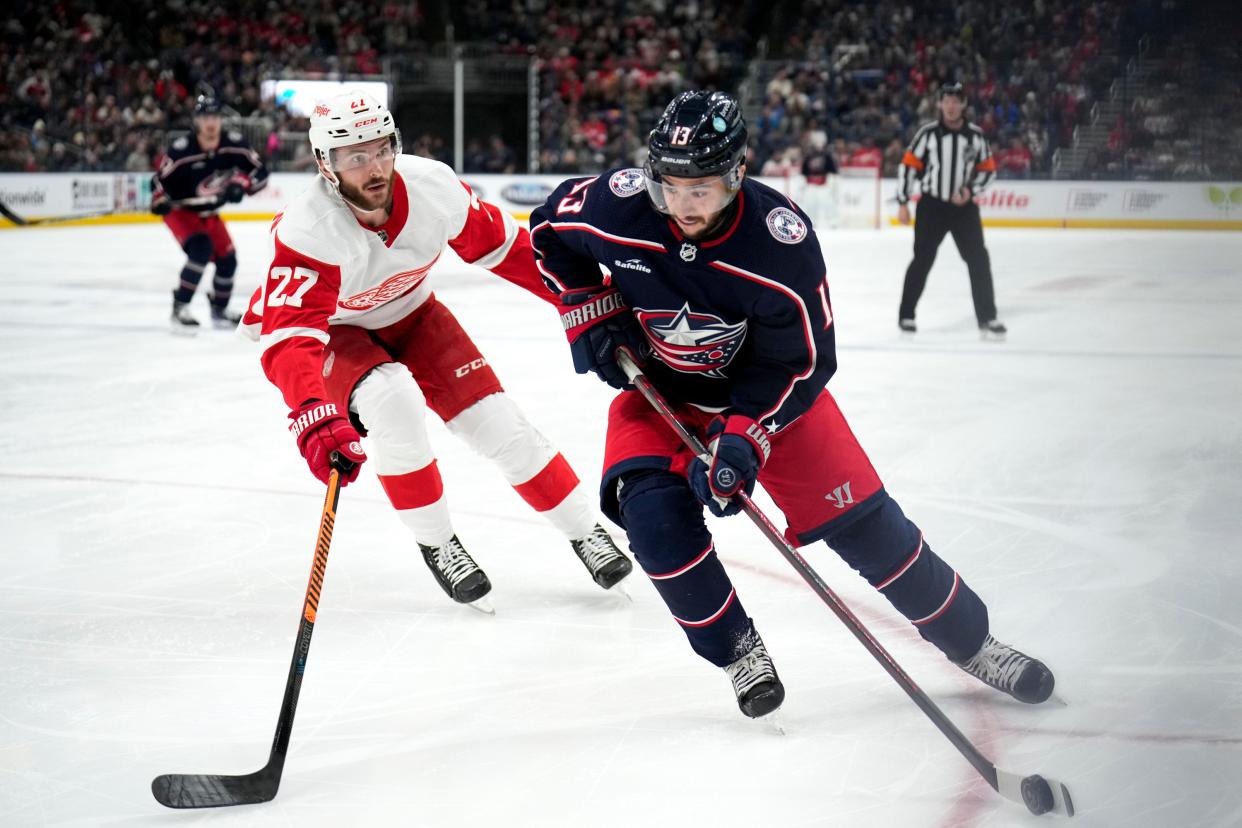 Nov 19, 2022; Columbus, Ohio, United States; Columbus Blue Jackets forward Johnny Gaudreau (13) contests the puck with Detroit Red Wings forward Michael Rasmussen (27) during the first period of the hockey game between the Columbus Blue Jackets and the Detroit Red Wings at Nationwide Arena. Mandatory Credit: Joseph Scheller-The Columbus Dispatch