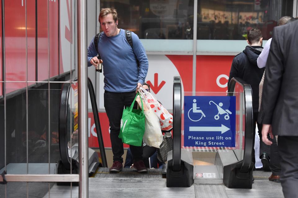 A shopper is seen carrying bags at a Coles Sydney CBD store.