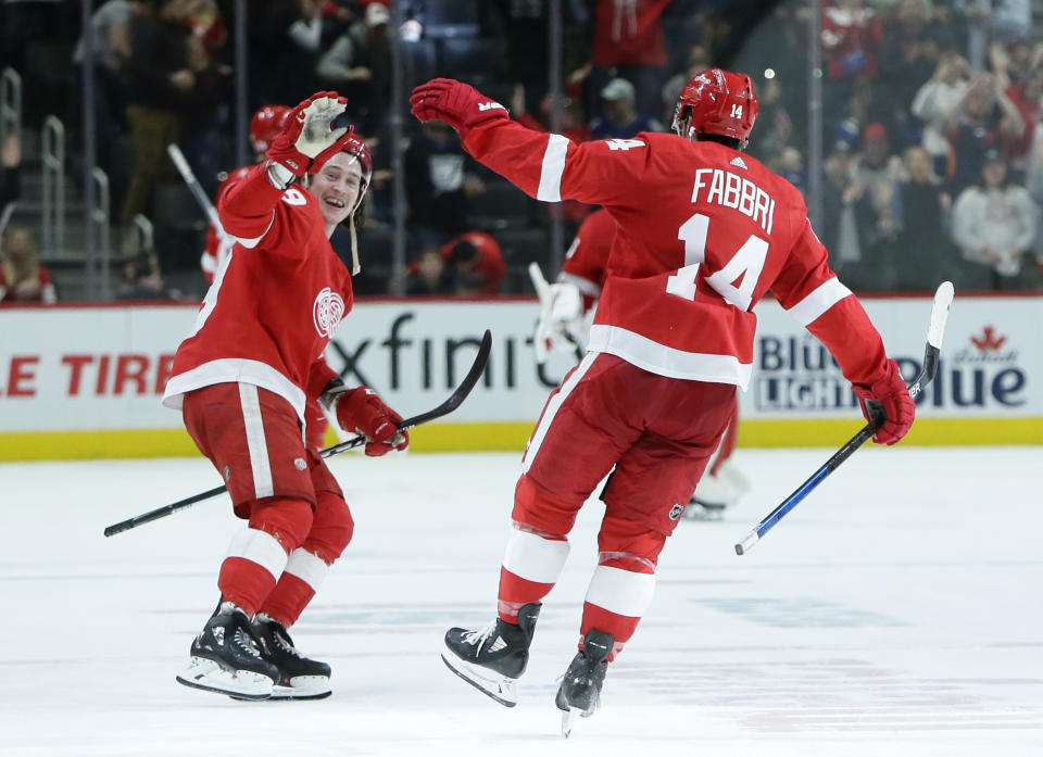 Detroit Red Wings center Robby Fabbri (14) celebrates with Red Wings left wing Tyler Bertuzzi, left, after scoring to win the shootout 2-1 against the Tampa Bay Lightning in NHL hockey game Sunday, March 8, 2020, in Detroit. The Red Wings defeated Tampa 5-4. (AP Photo/Duane Burleson)