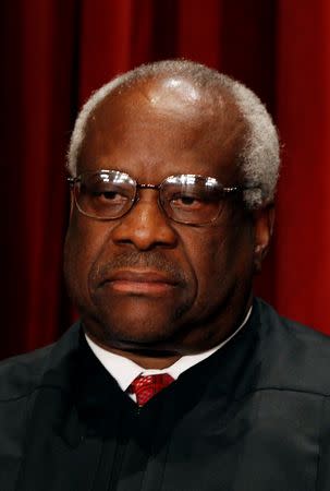 Clarence Thomas poses for a portrait in the East Conference Room at the Supreme Court Building in Washington October 8, 2010. REUTERS/Larry Downing