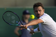 Switzerland's Stan Wawrinka returns the ball to Italy's Jannik Sinner during their men's singles match on day one of the Wimbledon tennis championships in London, Monday, June 27, 2022. (AP Photo/Alastair Grant)