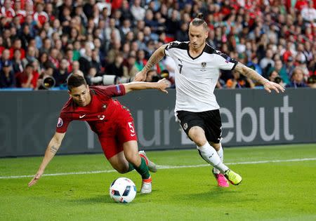 Football Soccer - Portugal v Austria - EURO 2016 - Group F - Parc des Princes, Paris, France - 18/6/16 Portugal's Raphael Guerreiro in action with Austria's Marko Arnautovic REUTERS/Darren Staples Livepic