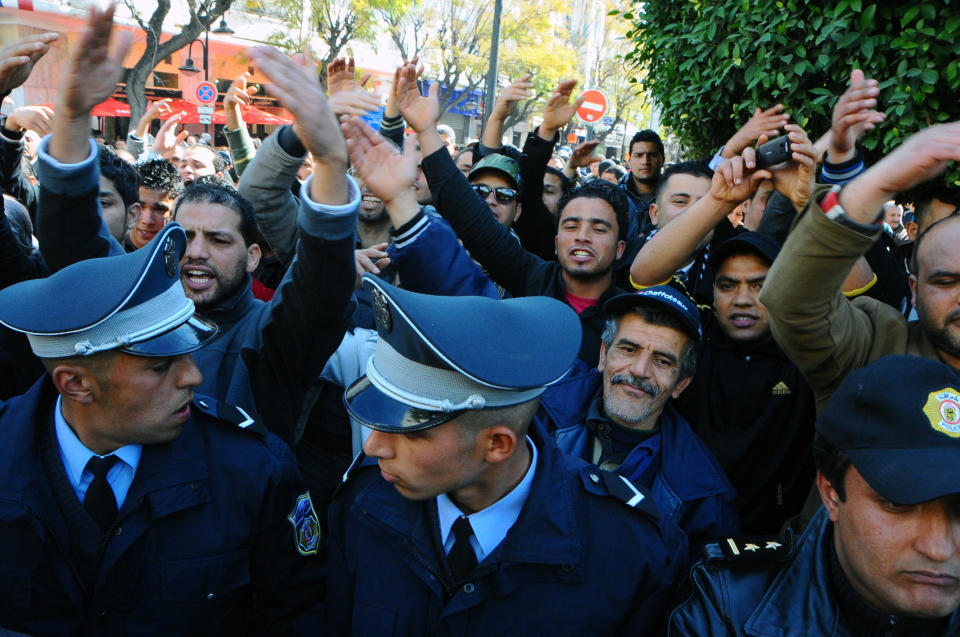 Protestors shout slogans during a demonstration to denounce the Islamist-led government, in Tunis, Saturday, Feb 25, 2012. More than 4,000 members of Tunisia's main trade union marched through the center of the capital, prompted by attacks on the union's offices around the country, which it blamed on members of Ennahda, the moderate Islamist party that won elections in October(AP Photo/Hassene Dridi)