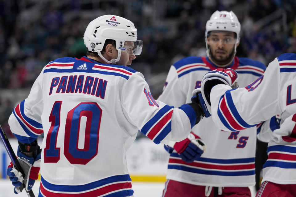 New York Rangers left wing Artemi Panarin, left, celebrates with teammates after scoring against the San Jose Sharks during the second period of an NHL hockey game Tuesday, Jan. 23, 2024, in San Jose, Calif. (AP Photo/Godofredo A. Vásquez)