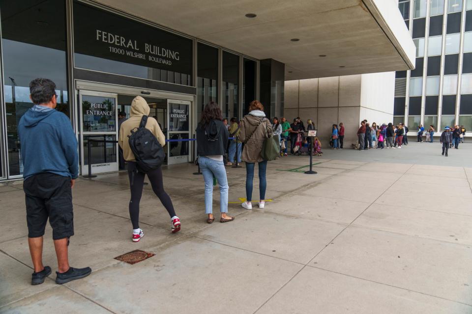 People wait in line outside the Los Angeles Passport Agency at the Federal Building in Los Angeles on Wednesday, June 14, 2023.  A much-feared backup of U.S. passport applications has snarled post-pandemic summer plans for would-be travelers around the world.