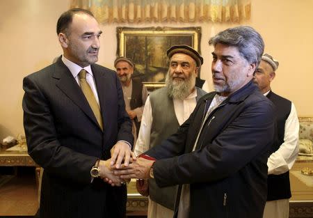 Governor of Mazar-i-Sharif Atta Mohammad Noor (L) shakes hands with tribe elders in Mazar-i-Sharif May 26, 2015. REUTERS/Anil Usyan