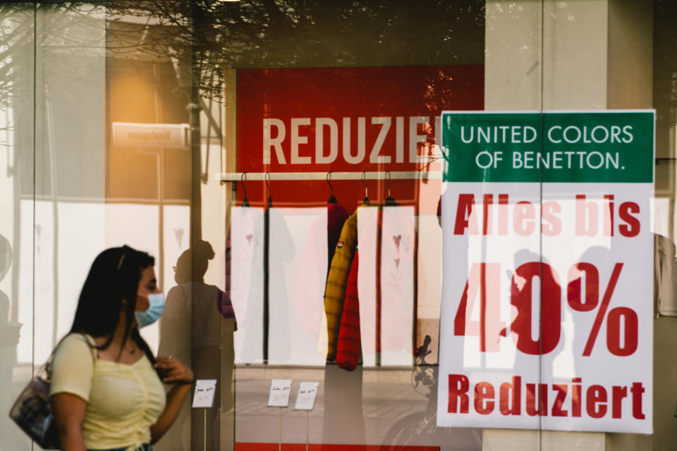 a woman walks pass a reduced price sign in the city center of Bonn, Germany on March 31, 2021 as city bonn launches shopping with 24 hours coronavirus negative test due to increasing infection cases in Germany (Photo by Ying Tang/NurPhoto via Getty Images)