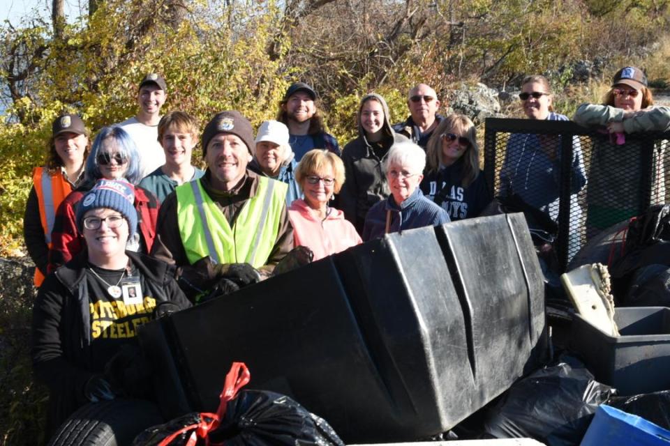 Volunteers pose with their haul after cleaning up more than 700 pounds of trash from the beaches at Cedar Point National Wildlife Refuge in Oregon on Sunday.