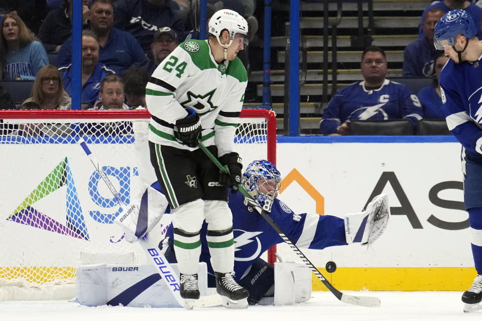 Dallas Stars center Roope Hintz (24) tries to deflect the puck past Tampa Bay Lightning goaltender Andrei Vasilevskiy (88) during the second period of an NHL hockey game Monday, Dec. 4, 2023, in Tampa, Fla. (AP Photo/Chris O'Meara)