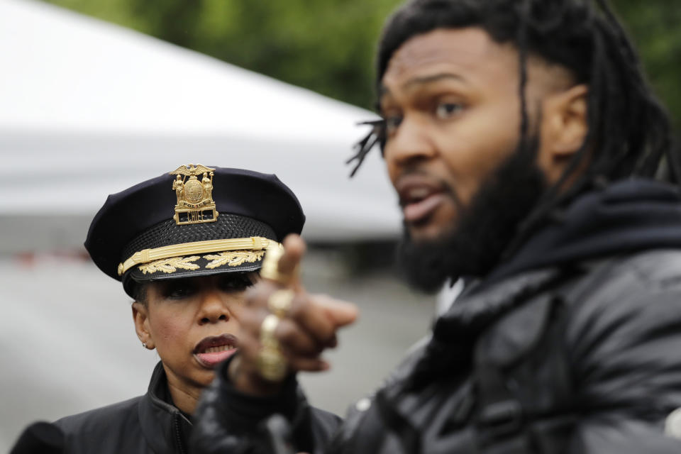 Seattle Police Chief Carmen Best, left, listens to activist Raz Simone as they talk near a plywood-covered and closed Seattle police precinct Tuesday, June 9, 2020, in Seattle, following protests over the death of George Floyd. Floyd, a black man died after being restrained by Minneapolis police officers on May 25. Under pressure from city councilors, protesters and dozens of other elected leaders who have demanded that officers dial back their tactics, the police department on Monday removed barricades near its East Precinct building in the Capitol Hill neighborhood, where protesters and riot squads had faced off nightly. Protesters were allowed to march and demonstrate in front of the building, and the night remained peaceful. (AP Photo/Elaine Thompson)