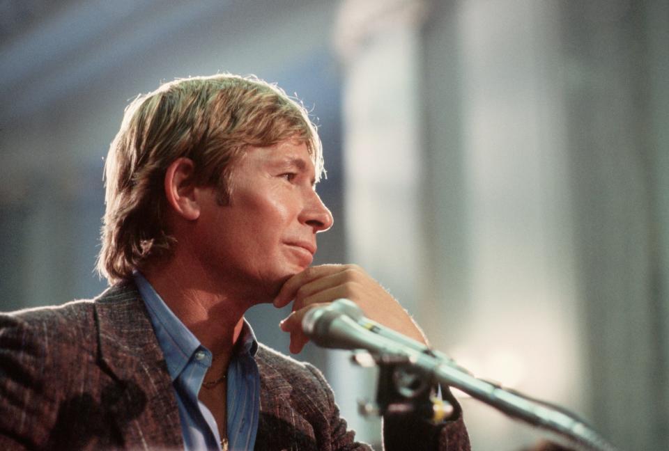 Singer John Denver strongly objects to the proposed government regulation of lyrics at a 1985 Senate committee hearing. Denver said he was against all censorship, and pointed out that his song, “Rocky Mountain High”, had been banned by many radio stations for his use of the word ‘high’. (Credit: Wally McNamee/CORBIS/Corbis via Getty Images)