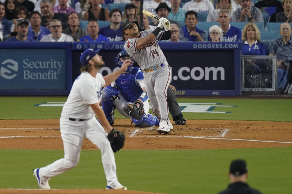Arizona Diamondbacks' Gabriel Moreno, right, watches his three-run home run as Los Angeles Dodgers starting pitcher Clayton Kershaw looks on during the first inning in Game 1 of a baseball NL Division Series Saturday, Oct. 7, 2023, in Los Angeles. (AP Photo/Mark J. Terrill)
