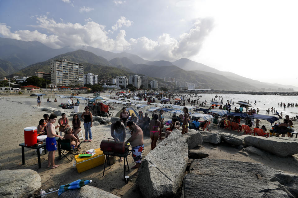 A family from Caracas prepares food during a day trip to Camuri Chico beach in Vargas state, Venezuela, Friday, March 1, 2019. It’s carnival season in Venezuela, though many citizens are not in a mood to party, as the country is gripped by a political crisis that pits leader Nicolas Maduro against Juan Guaido, the opposition chief who was in Paraguay on Friday as part of a campaign to build international pressure on his rival to quit. (AP Photo/Eduardo Verdugo)