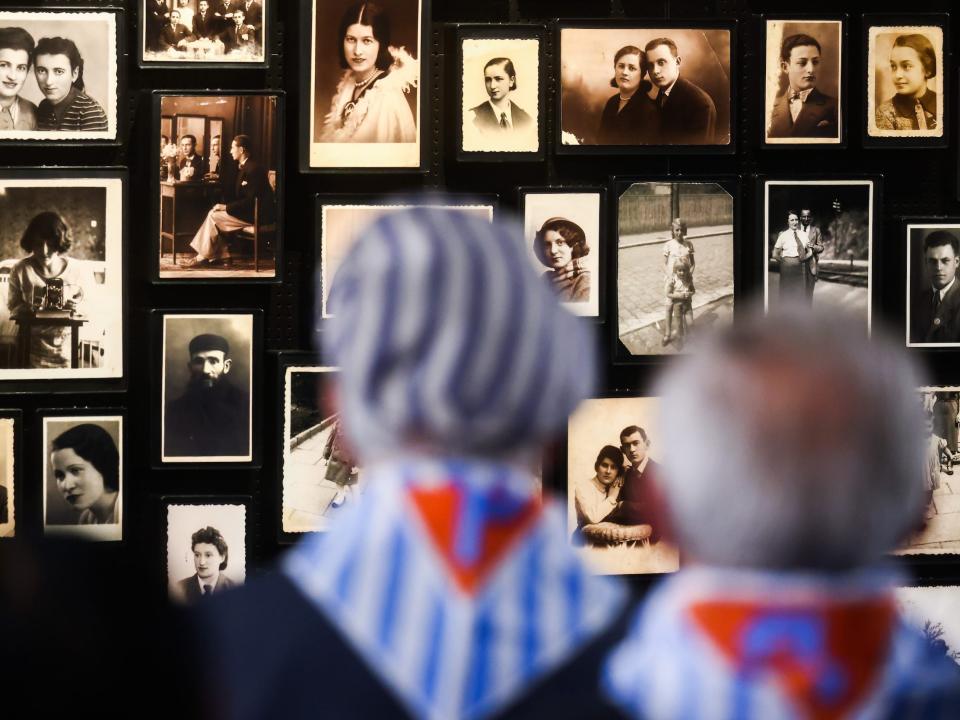 Holocaust survivors wearing striped scarves during 78th Anniversary Of Auschwitz - Birkenau Liberation