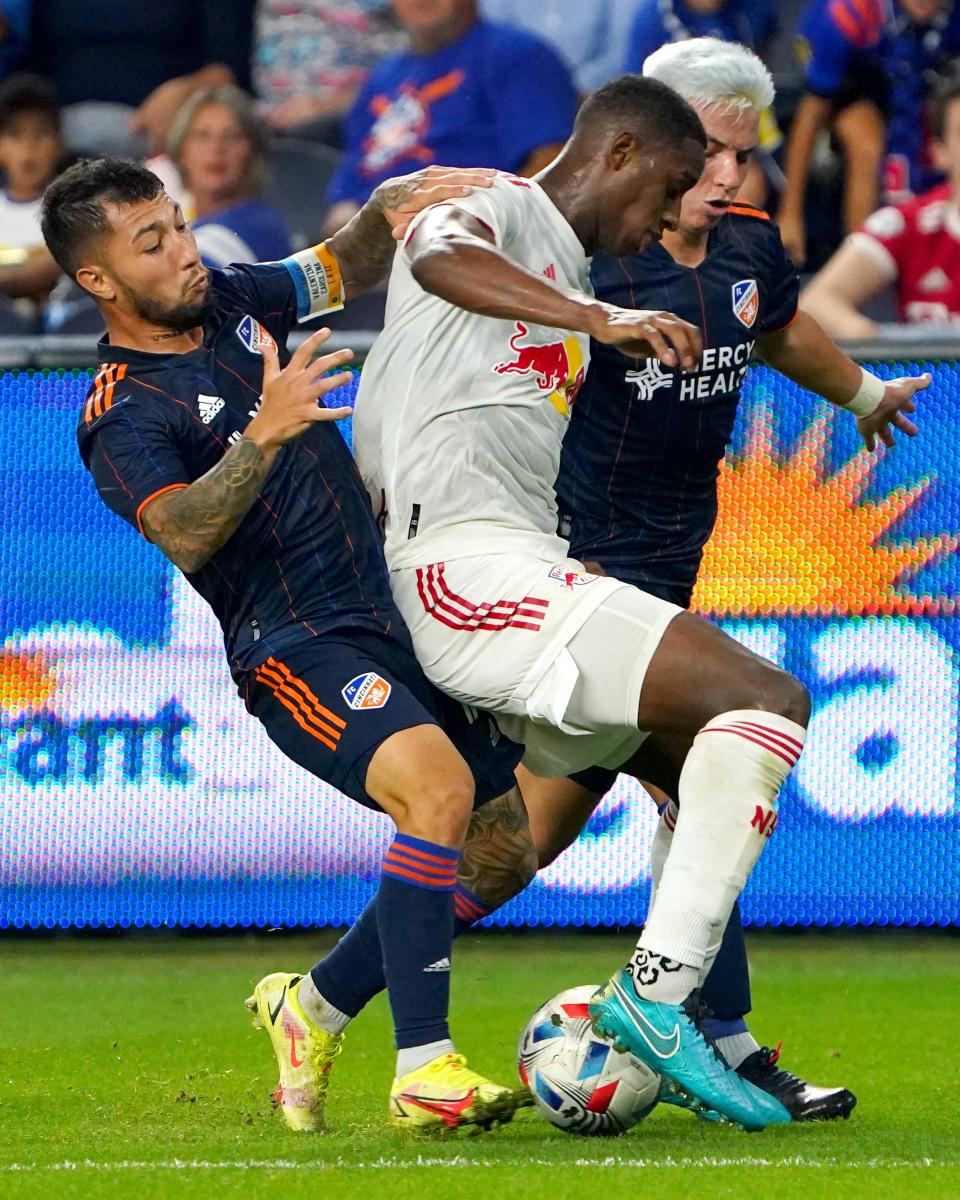 FC Cincinnati midfielder Luciano Acosta (11) and FC Cincinnati midfielder Alvaro Barreal (31), challenge New York Red Bulls defender Andres Reyes (4) for the ball in the second half of an MLS soccer game, Saturday, Oct. 2, 2021, at TQL Stadium in Cincinnati. 