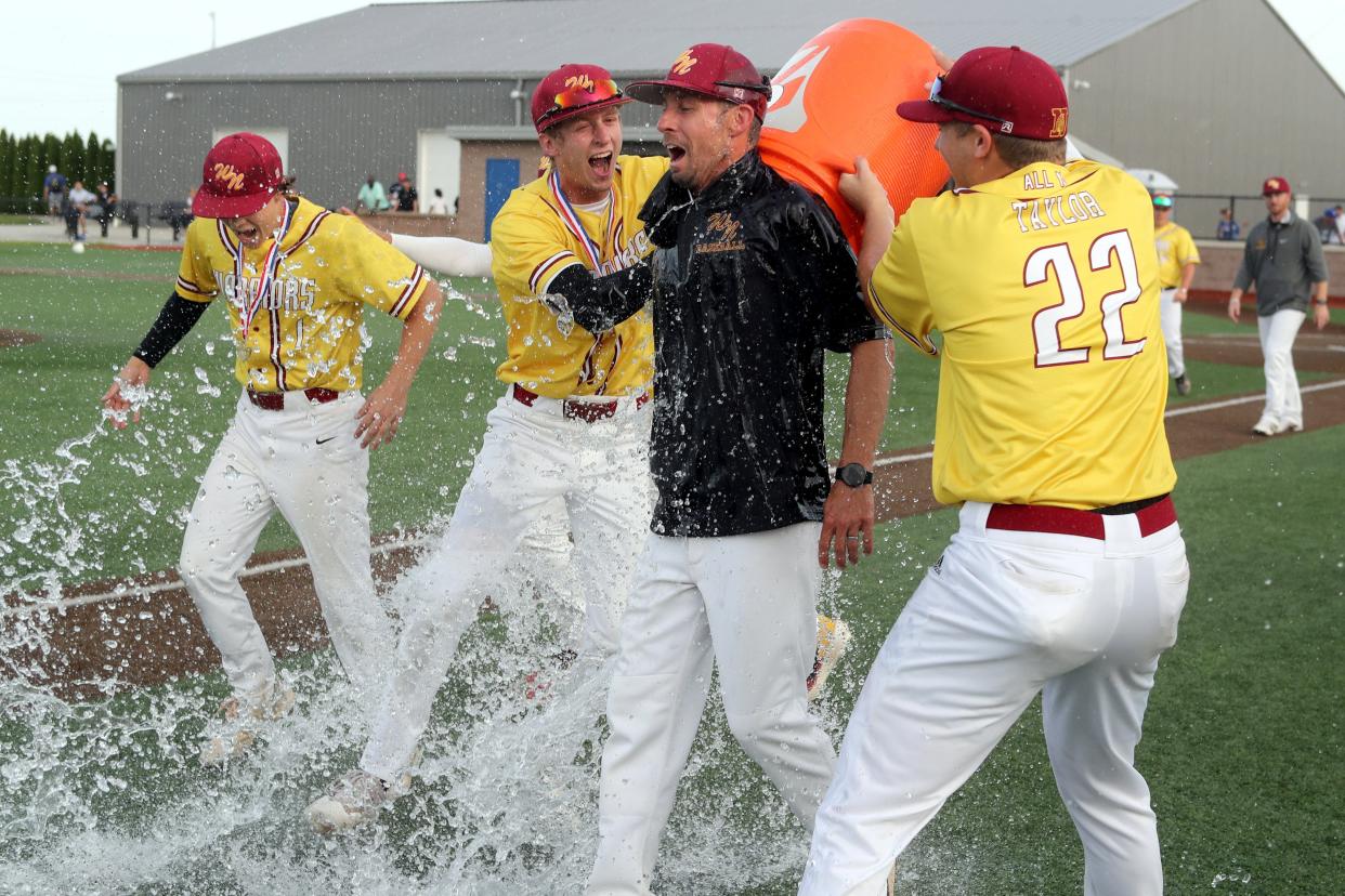 Westerville North's Zac Taylor (22) and Aiden Dickinson (7) shower coach Sean Ring in water following a 3-2 win over Central Crossing in a Division I district final May 25 at Olentangy Liberty.