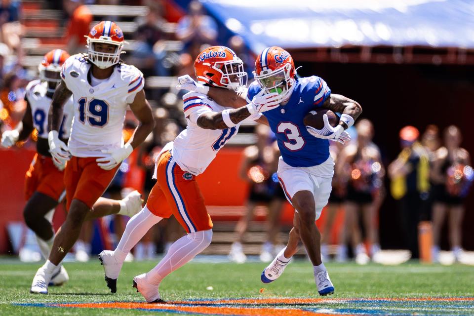 Florida Gators wide receiver Eugene Wilson III (3) stiff arms Florida Gators defensive back Sharif Denson (0) during the first half at the Orange and Blue spring football game at Steve Spurrier Field at Ben Hill Griffin Stadium in Gainesville, FL on Saturday, April 13, 2024. [Matt Pendleton/Gainesville Sun]