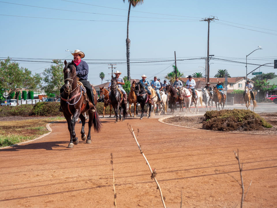 Vaqueros ride through Greenleaf Park before joining hundreds more for a cabalgata on Sept. 20, 2020. (Connecting Compton)