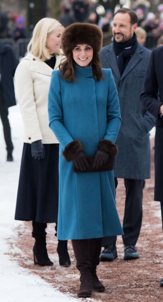 <p>The Duchess of Cambridge donned a teal Catherine Walker coat with Cornelia James $157 faux fur gloves. She accessorized the look with her go-to boots by Stuart Weitzman ($795) and a co-ordinating suede clutch by the same label ($480). </p>