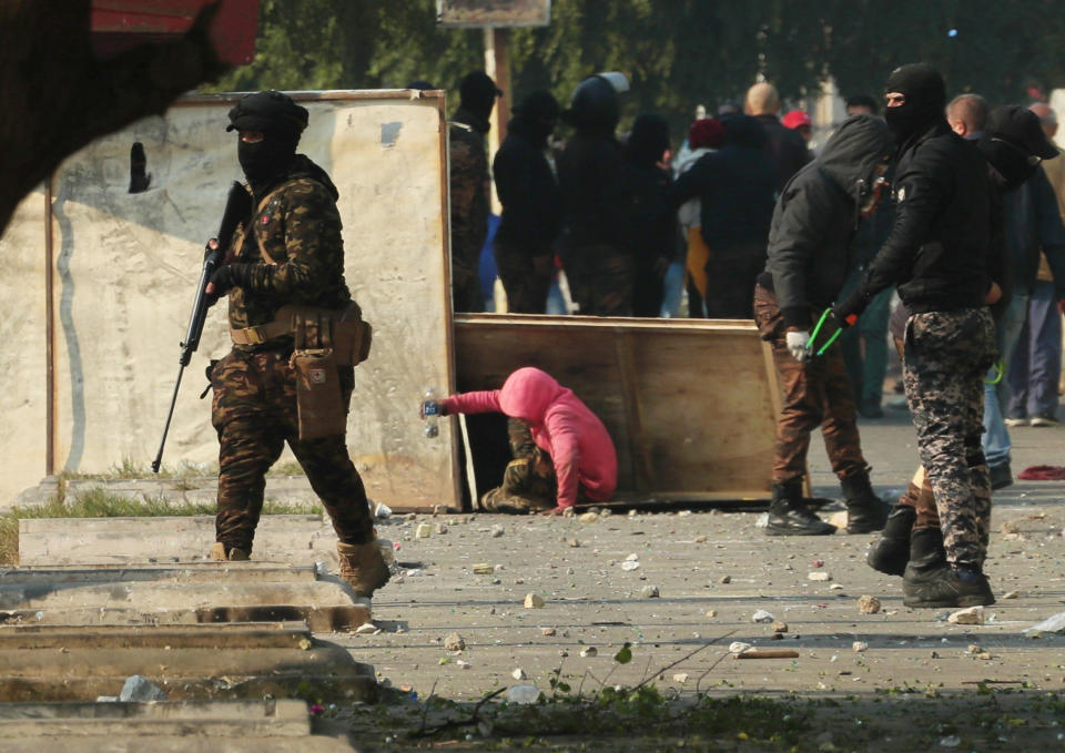 Riot police, carries a pellet air rifle during clashes with anti-government protesters in downtown Baghdad, Iraq, Thursday, Jan. 30, 2020. (AP Photo/Hadi Mizban)